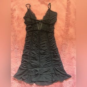 Black Cedar mini dress with v-shape, and ruffles at the bottom for a night out!
